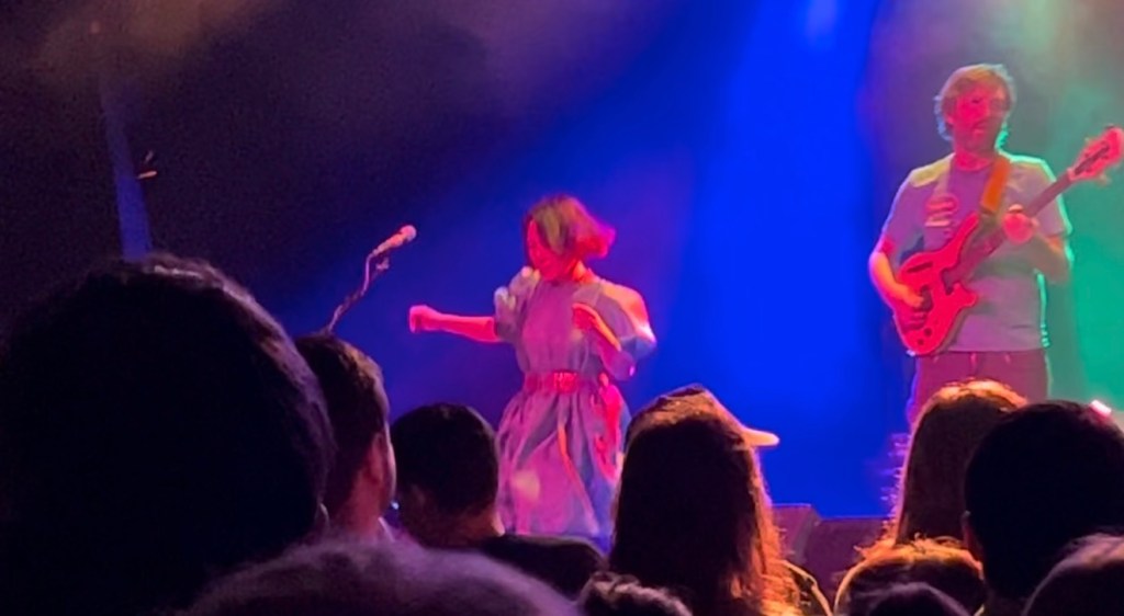 Still from Deerhoof concert of Satomi dancing